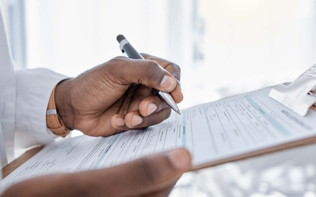 Person reviewing a document with a pen, a key part of California contractor verification before hiring