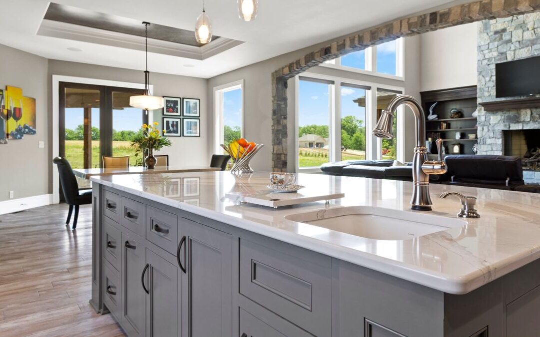 Open kitchen and living area with a stone fireplace, a space a heat pump retrofit would need to heat and cool evenly