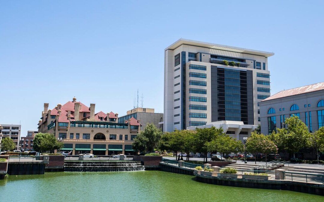 Older building on the Sacramento riverfront near modern towers, where Sacramento historic remodeling rules may apply